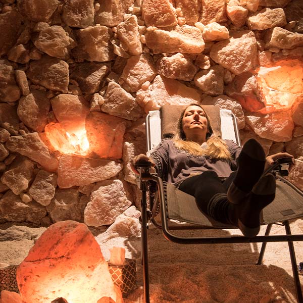 A woman relaxing n a salt room.