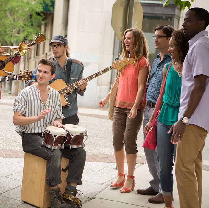 A group of musicians gathered in a circle.