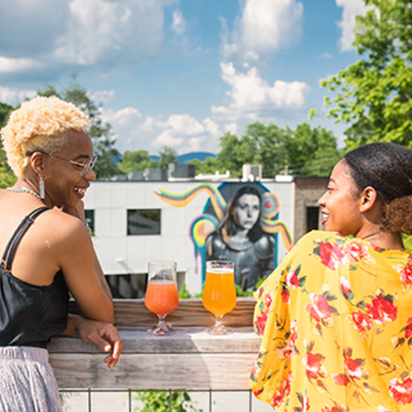 Two women enjoying a drink outside.