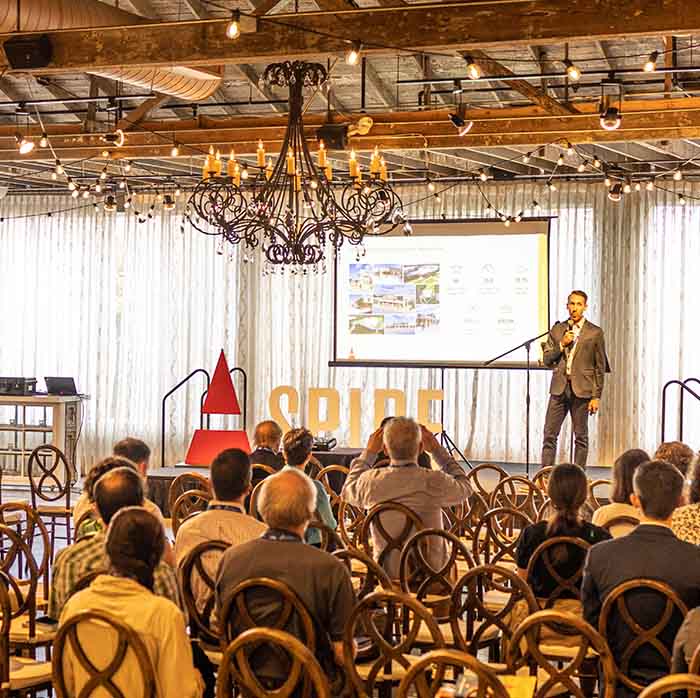 A man presenting at a venue.