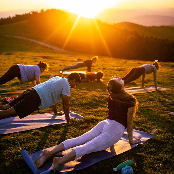 Individuals participating in a group yoga session.