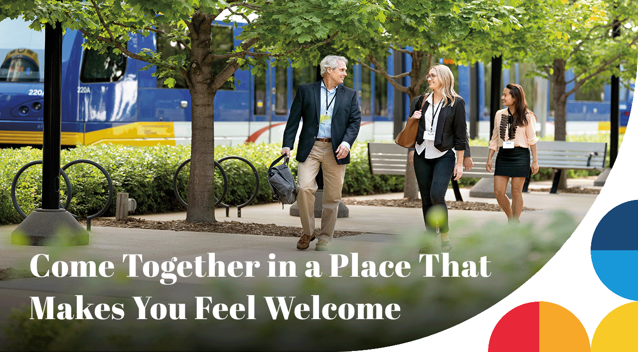 A photo of a group in business attire walking down a path. A headline reads: Come Together in a Place That Makes You Feel Welcome.