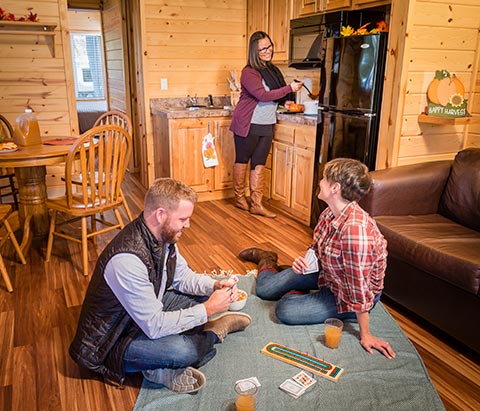 Family playing games inside a cabin