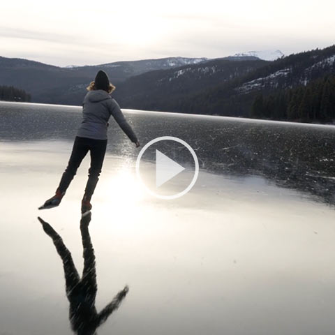 Woman skating across a frozen lake.