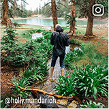 Woman hiking in the woods after a rain. Instagram @holly.mandarich