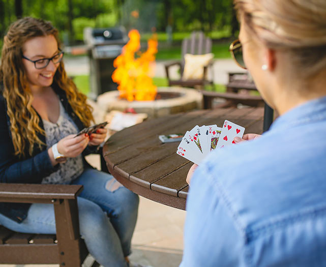 Ladies playing cards outside.