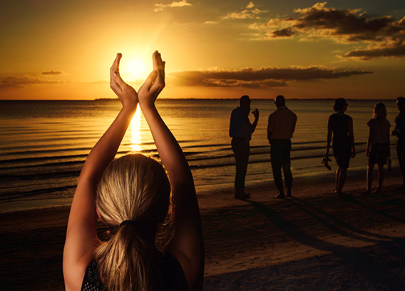 A woman posing on the beach.