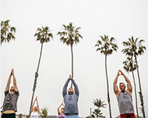 A group taking a private yoga class