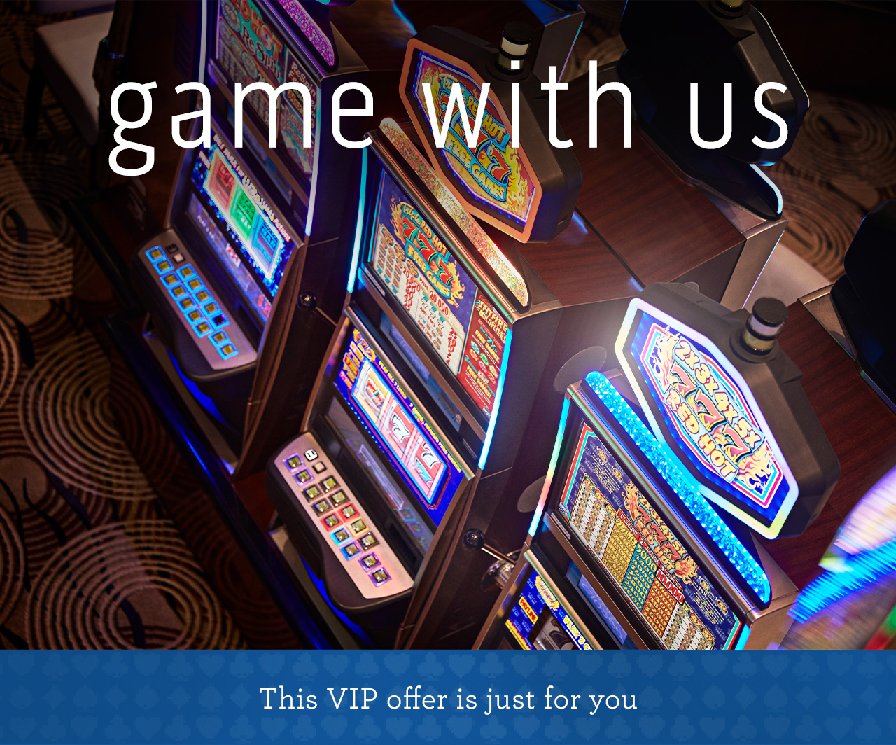 Image looking down at a row of illuminated colorful slot machines in the casino | game with us - This VIP offer is just for you