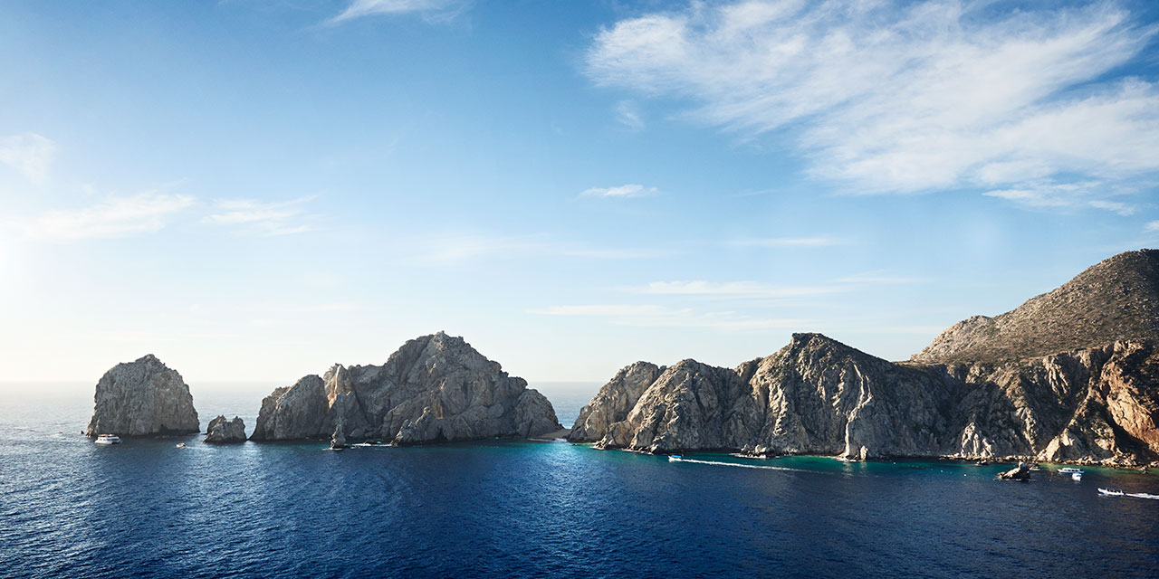 Rocks jut from the water in Los Cabos
