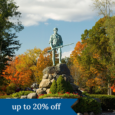 A statue surrounded by fall foliage in New England. Click here to book.