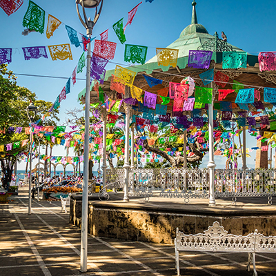 Festive flags decorating a gazebo in Mexico. Click here to book.