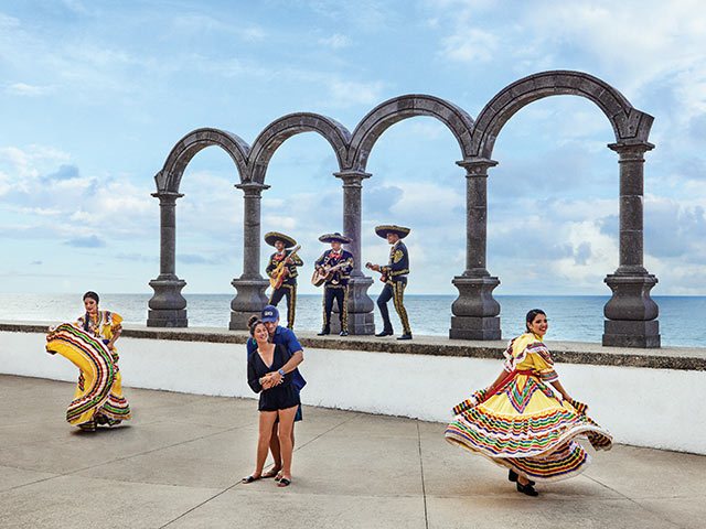 A couple dances to mariachi music. Click here to book. 