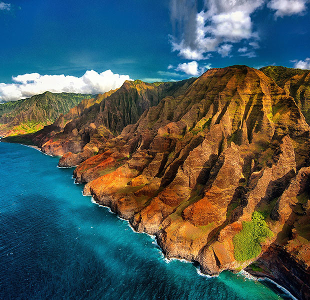 The vibrant Hawaii coastline surrounded by ocean. Click here to book.