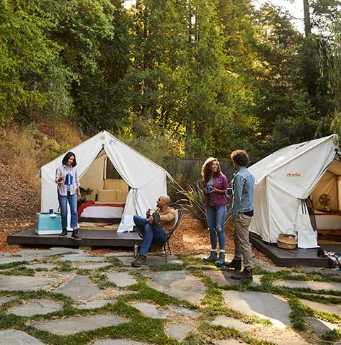 Two couples camping in luxury tents.