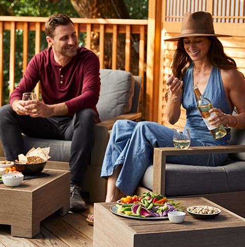 A couple enjoying wine on a patio.