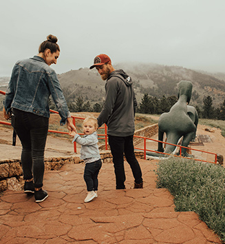 Family at dinosaur attraction with their toddler