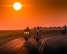 Riding a motorcycle down the open road. 