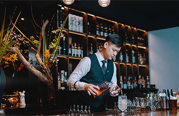 A bartender mixing a drink