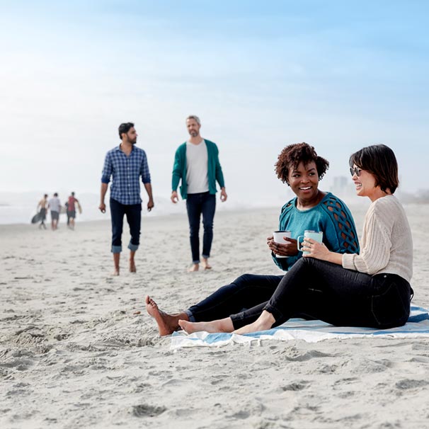  photo of friends hanging out at the beach.