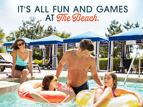 A family enjoys a swimming pool. A headline reads: It's All Fun And Games At The Beach.