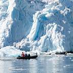 Paddle boat near large glacier