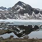 Snowy mountain reflecting off the ocean